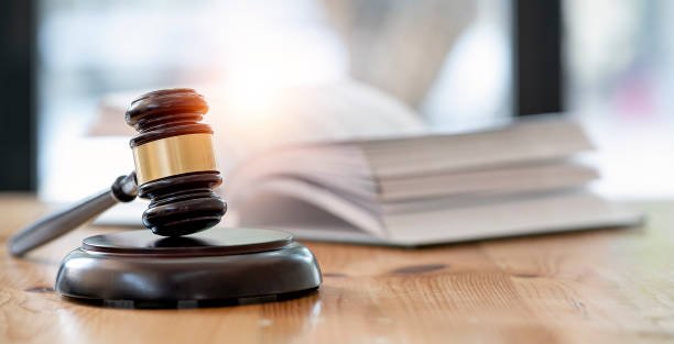 Court's brown wooden hammer on the desk 